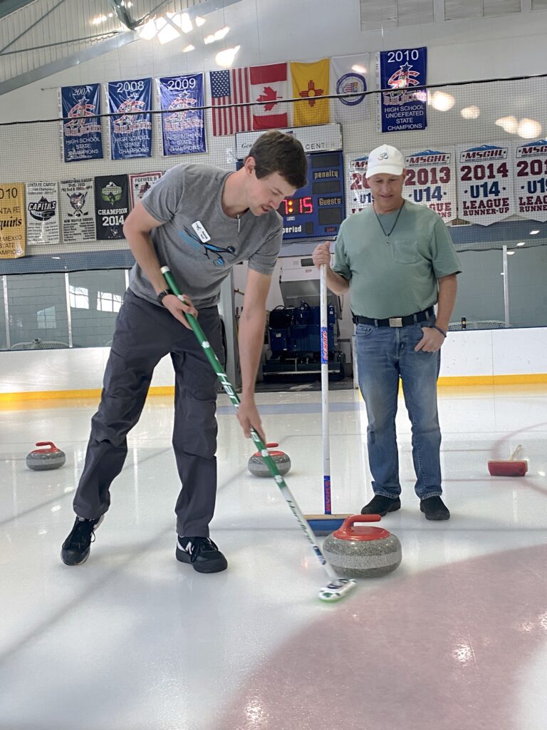 Patrick teaches curling sweeping
